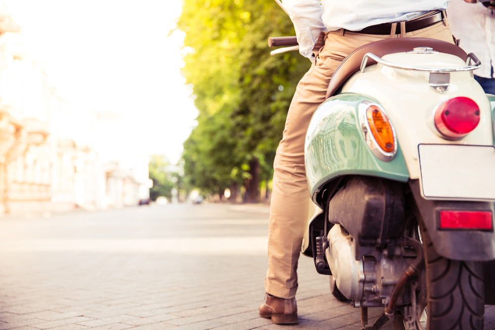 Closeup portrait of a scooter with male legs outdoors